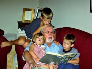 Charlie Leaumont reads to his grandchildren.