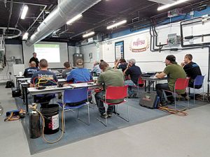 Charles McCracken, Senior HVAC Technical Advisor at CLEAResult, leads an AC Check class at Air Purchases in Burlington, MA.