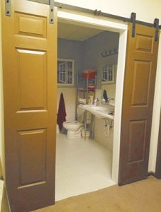 New entryway after the remodel which provided a wider doorway, a roll-under sink, and moved the lavatory to make it accessible.