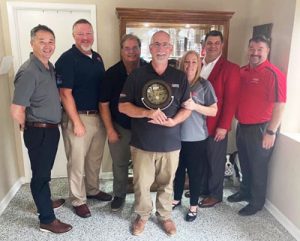 2020 Bryant Dealer of the Year Family Heating and Air, of Pensacola, Florida, left to right: Richard Fletcher, Carrier; Rick Center, Mingledorff's; Randy Ponson, Mingledorff's; David Fowler holding award, Family Heating and AC; Sonya Fowler, Family Heating and AC; Kelly Harvey, Mingledorff's; Michael Hopkins, Mingledorff's.